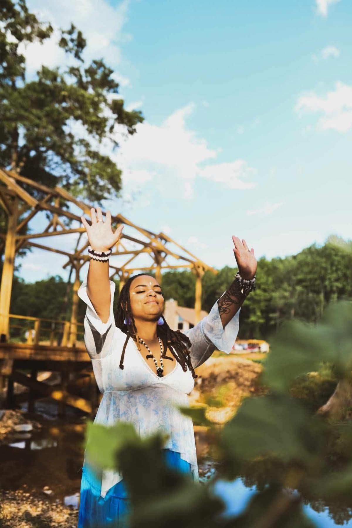 Hands raised to the sky at the timber frame